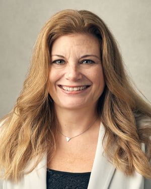 Woman with medium length blonde hair smiling